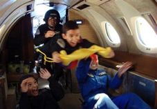  In this photo released by Ecuador's Civil Space Aviation Agency, Jules Nader, 7, center, floats with his brother Gerard Nader, 10, bottom left, and friend Julia Velastegui, 17, behind right, during a zero-gravity flight in an air force plane in Guayaquil, Ecuador, Thursday, June 19, 2008. 