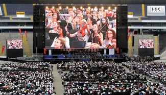  7,548 musicians gathered in a football stadium in Frankfurt to play for 45 minutes, conducted by Wolf Kerschek.
